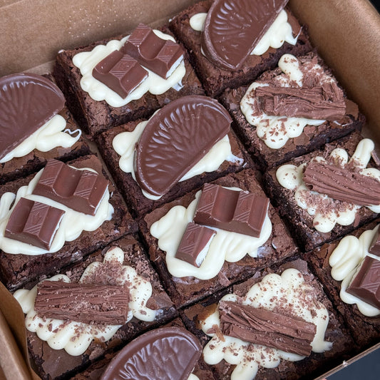 Box of brownies with white chocolate and chocolate decorations